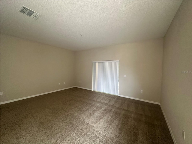 10595 Regent Square Dr Unit 1208, Orlando, FL 32825 - unfurnished room with dark carpet, baseboards, a textured ceiling, and visible vents