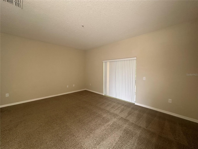 10595 Regent Square Dr Unit 1208, Orlando, FL 32825 - unfurnished room featuring dark carpet, baseboards, a textured ceiling, and visible vents