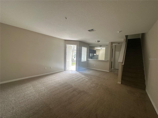 10595 Regent Square Dr Unit 1208, Orlando, FL 32825 - unfurnished room featuring light colored carpet, stairs, baseboards, a textured ceiling, and visible vents