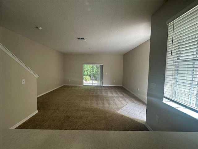 10595 Regent Square Dr Unit 1208, Orlando, FL 32825 - empty room with baseboards, carpet floors, a textured ceiling, and visible vents