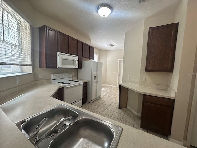 10595 Regent Square Dr Unit 1208, Orlando, FL 32825 - kitchen with a sink, a textured ceiling, light tile patterned floors, white appliances, and dark brown cabinets