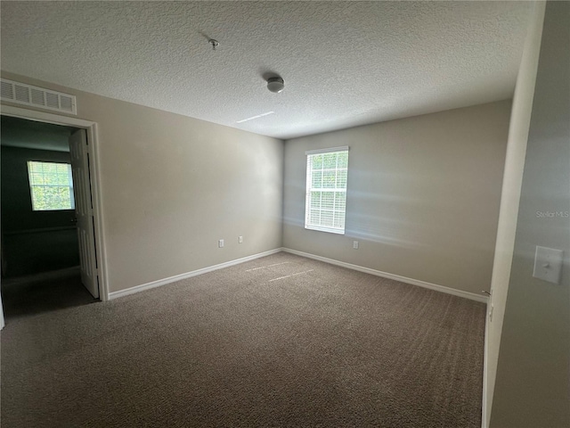 10595 Regent Square Dr Unit 1208, Orlando, FL 32825 - spare room featuring baseboards, a textured ceiling, visible vents, and carpet