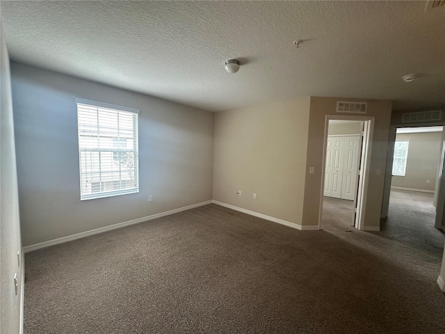10595 Regent Square Dr Unit 1208, Orlando, FL 32825 - carpeted spare room with a textured ceiling, baseboards, and visible vents