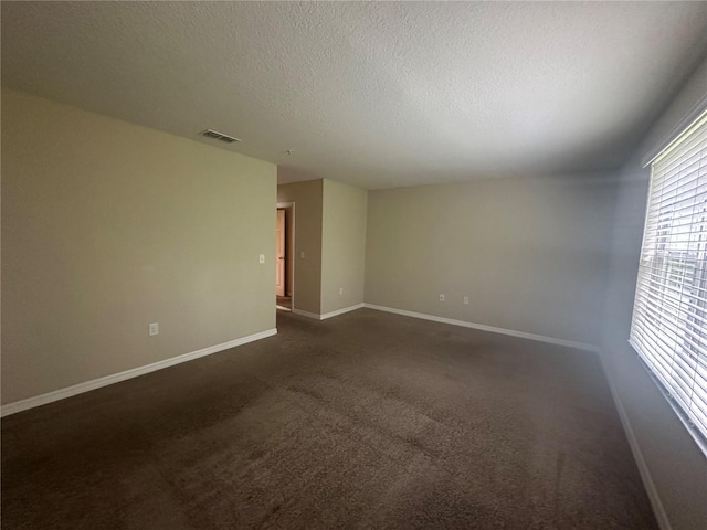 10595 Regent Square Dr Unit 1208, Orlando, FL 32825 - empty room with baseboards, a textured ceiling, visible vents, and dark carpet