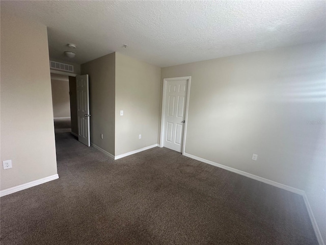 10595 Regent Square Dr Unit 1208, Orlando, FL 32825 - spare room featuring baseboards, visible vents, dark carpet, and a textured ceiling