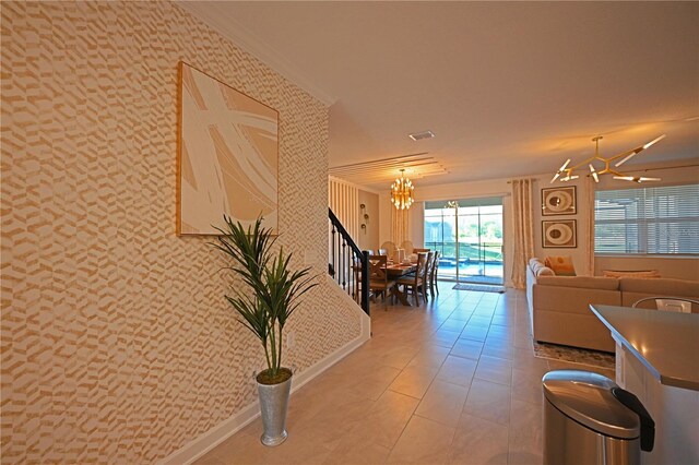 4221 Paragraph Dr, Kissimmee, FL 34746 - hallway with wallpapered walls, a notable chandelier, and baseboards