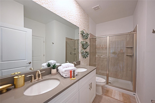 4221 Paragraph Dr, Kissimmee, FL 34746 - bathroom featuring toilet, a sink, a stall shower, and double vanity