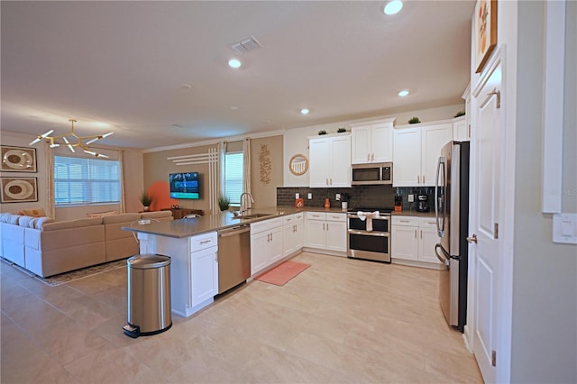 4221 Paragraph Dr, Kissimmee, FL 34746 - kitchen with a sink, a peninsula, open floor plan, stainless steel appliances, and visible vents