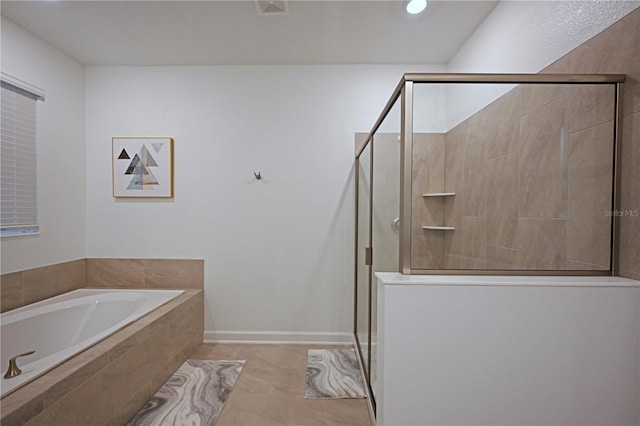 4221 Paragraph Dr, Kissimmee, FL 34746 - bathroom with tile patterned floors, a shower stall, a bath, baseboards, and visible vents