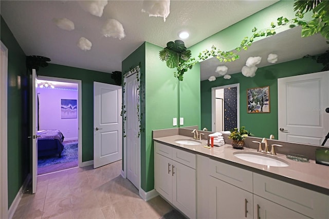 4221 Paragraph Dr, Kissimmee, FL 34746 - ensuite bathroom with double vanity, a sink, ensuite bathroom, and baseboards