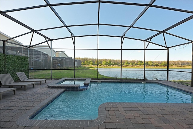 4221 Paragraph Dr, Kissimmee, FL 34746 - view of swimming pool featuring a pool with connected hot tub, a lanai, a water view, and a patio area