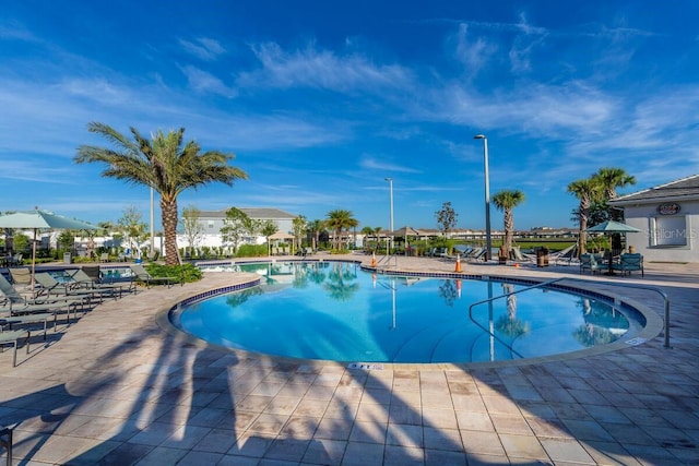 4221 Paragraph Dr, Kissimmee, FL 34746 - community pool featuring a patio area