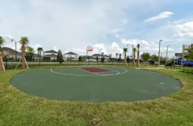 4221 Paragraph Dr, Kissimmee, FL 34746 - view of basketball court with community basketball court, fence, and a yard