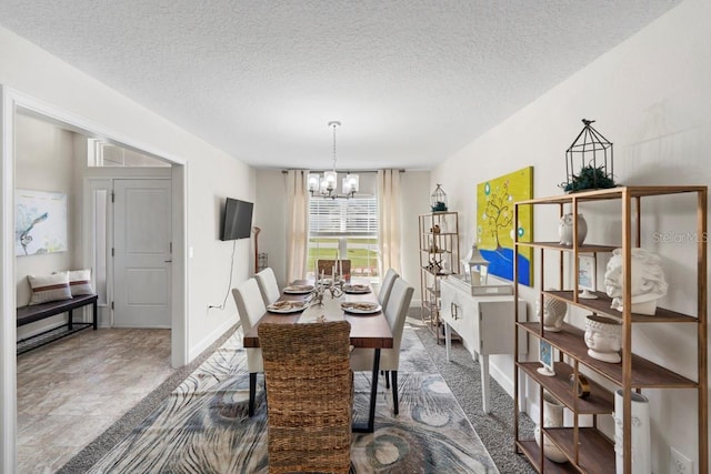 311 Athabasca Pl, Kissimmee, FL 34759 - dining area featuring baseboards, a textured ceiling, and a notable chandelier