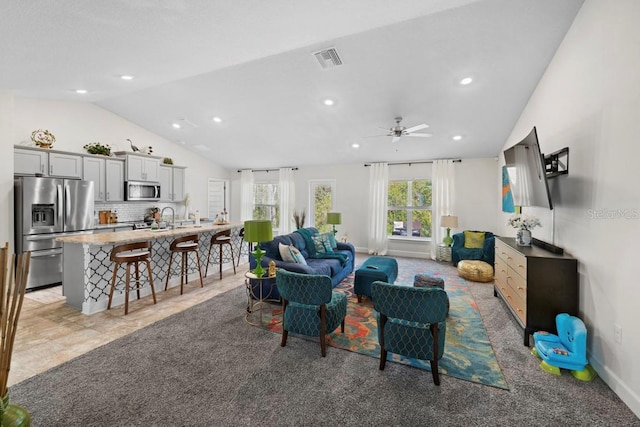 311 Athabasca Pl, Kissimmee, FL 34759 - living room with visible vents, ceiling fan, recessed lighting, vaulted ceiling, and light colored carpet