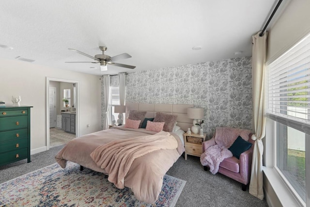 311 Athabasca Pl, Kissimmee, FL 34759 - bedroom with connected bathroom, carpet flooring, baseboards, wallpapered walls, and ceiling fan