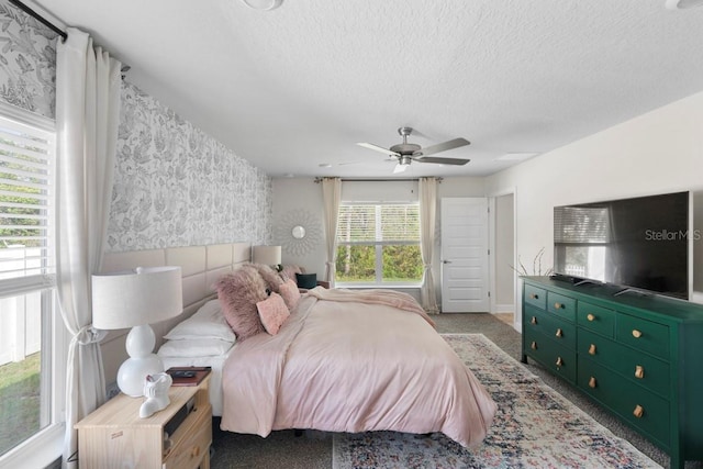 311 Athabasca Pl, Kissimmee, FL 34759 - carpeted bedroom featuring baseboards, wallpapered walls, a ceiling fan, and a textured ceiling
