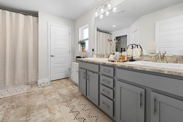 311 Athabasca Pl, Kissimmee, FL 34759 - bathroom with double vanity, visible vents, a sink, and a shower with shower curtain
