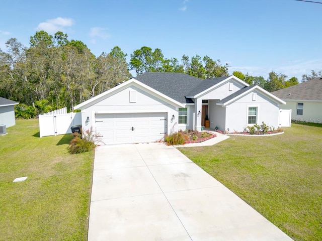 311 Athabasca Pl, Kissimmee, FL 34759 - view of front of home with a gate, fence, a garage, concrete driveway, and a front lawn