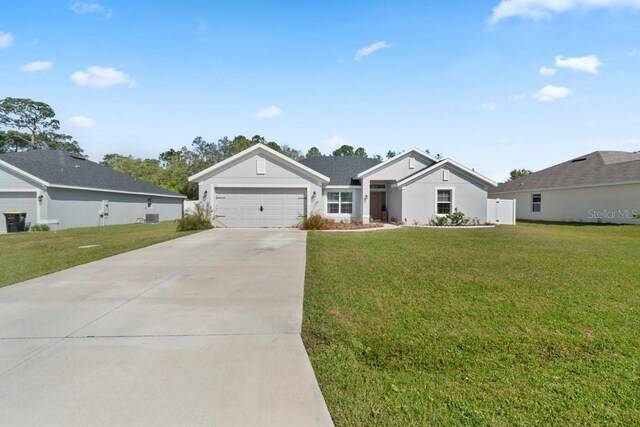 311 Athabasca Pl, Kissimmee, FL 34759 - ranch-style home featuring an attached garage, concrete driveway, and a front yard