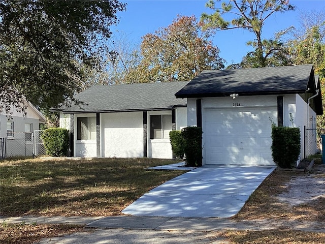 2948 Willow Bend Blvd, Orlando, FL 32808 - ranch-style home with driveway, roof with shingles, stucco siding, fence, and a garage