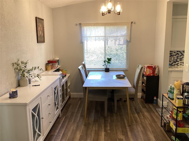 2948 Willow Bend Blvd, Orlando, FL 32808 - dining area with an inviting chandelier, dark wood-type flooring, baseboards, and a textured ceiling