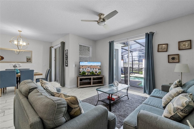 1566 Plunker Dr, Davenport, FL 33896 - living area featuring a textured ceiling, marble finish floor, and ceiling fan with notable chandelier