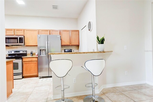 2934 Rodrick Cir, Orlando, FL 32824 - kitchen featuring decorative backsplash, visible vents, stainless steel appliances, and light tile patterned floors