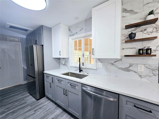 218 W Magnolia Ave, Longwood, FL 32750 - kitchen with stainless steel appliances, a sink, wood finished floors, gray cabinets, and open shelves