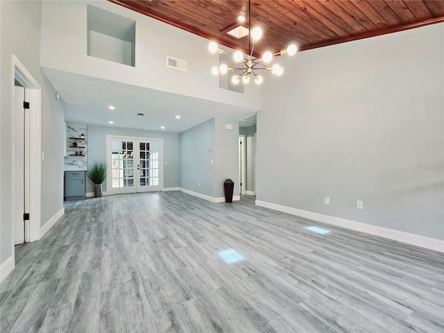 218 W Magnolia Ave, Longwood, FL 32750 - unfurnished living room featuring a chandelier, a high ceiling, wooden ceiling, baseboards, and visible vents
