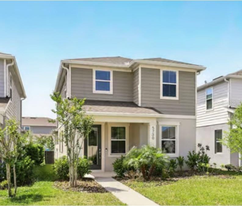 view of front of house featuring stucco siding and a front lawn