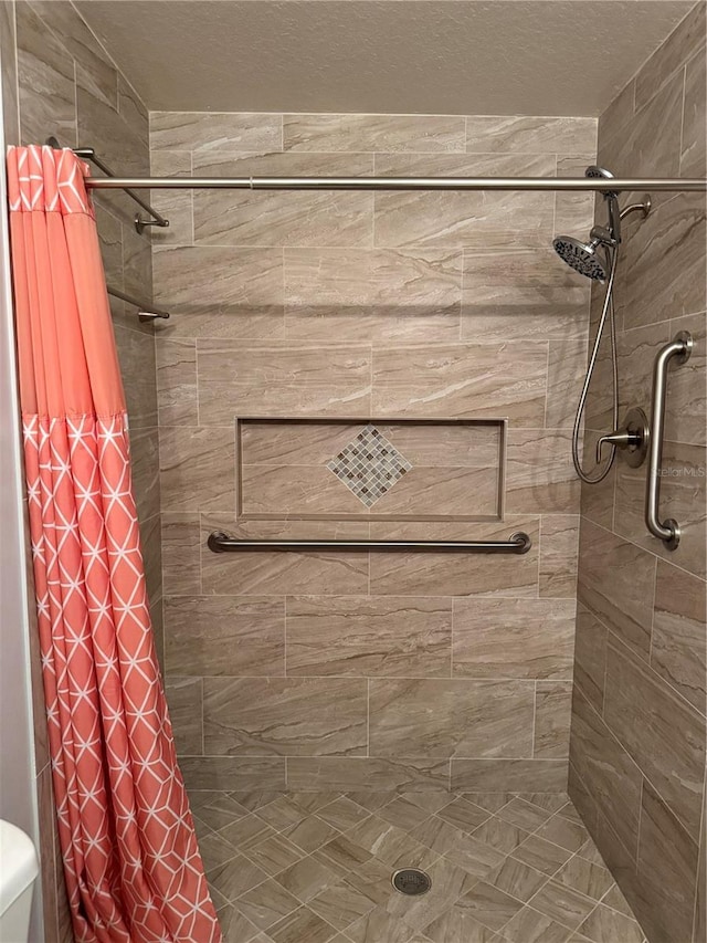 282 SE Walsh Ter, Port St Lucie, FL 34983 - bathroom featuring a shower stall, toilet, and a textured ceiling