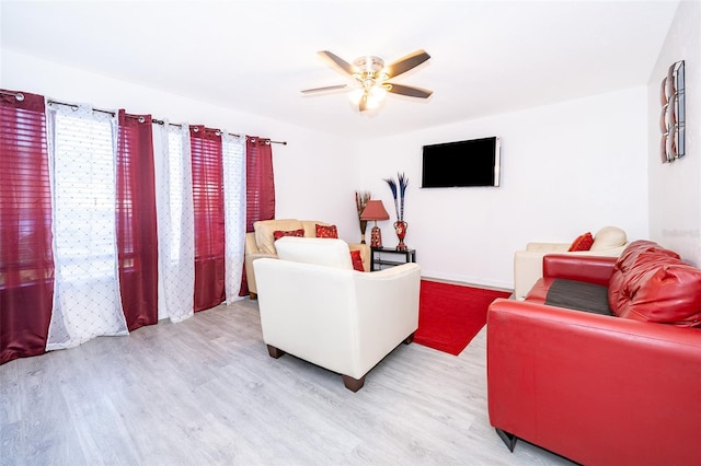 living room with light wood-style flooring and a ceiling fan