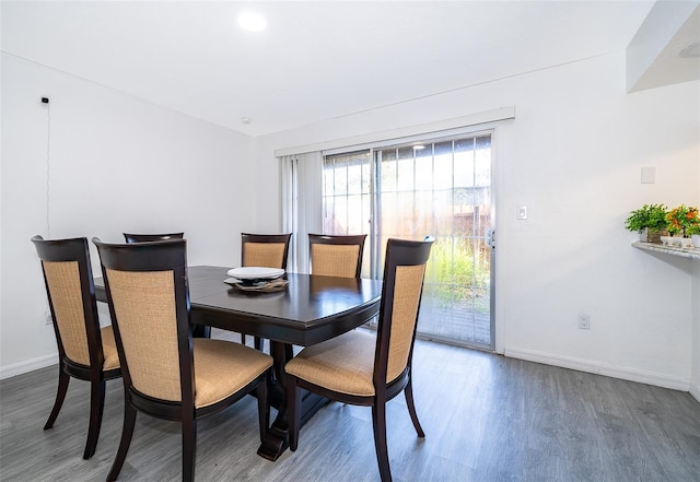 dining room featuring wood finished floors and baseboards