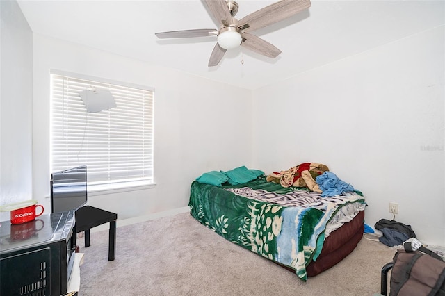 carpeted bedroom featuring ceiling fan and baseboards
