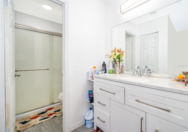 full bathroom with toilet, wood finished floors, and vanity
