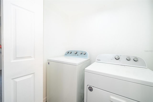 clothes washing area with washer and dryer and laundry area