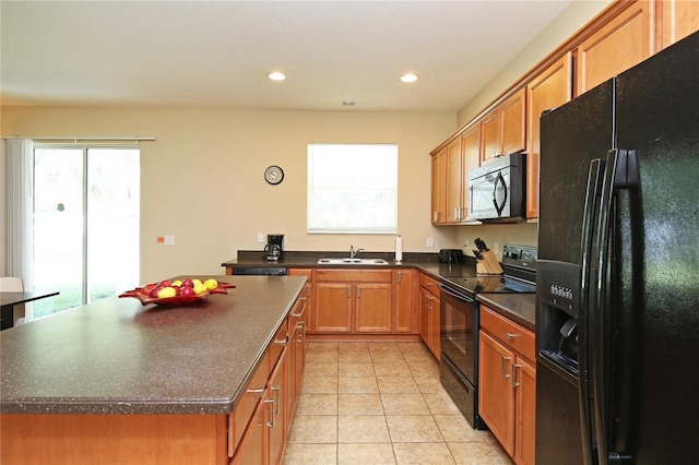 kitchen featuring black appliances, a sink, dark countertops, light tile patterned floors, and recessed lighting