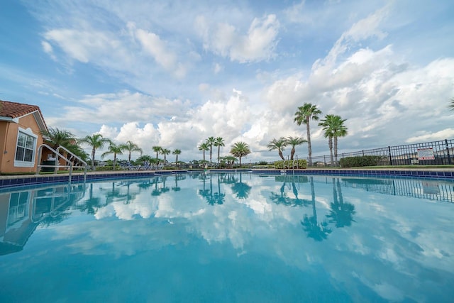 view of pool featuring fence