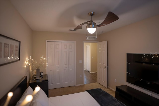 carpeted bedroom featuring a closet, a ceiling fan, and baseboards