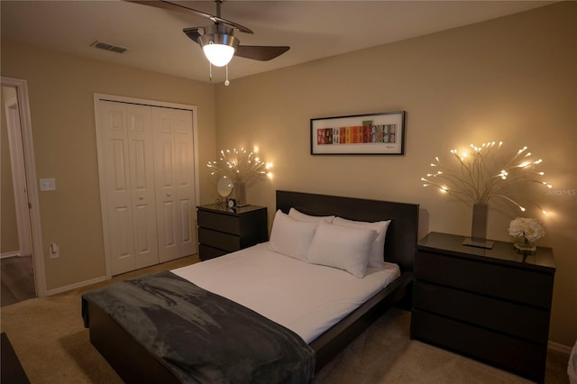bedroom with a closet, carpet flooring, baseboards, and a ceiling fan