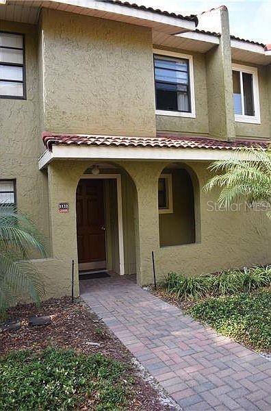 1122 Spaceport Ct, Kissimmee, FL 34741 - property entrance featuring stucco siding and a tiled roof
