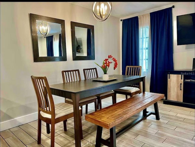 1122 Spaceport Ct, Kissimmee, FL 34741 - dining area with a chandelier, light wood-style floors, and baseboards