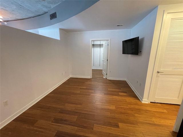 interior space with visible vents, baseboards, and wood finished floors