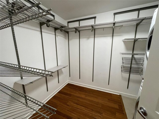 walk in closet with wood finished floors