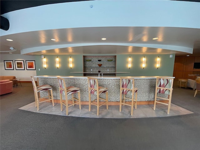 bar featuring a community bar, carpet flooring, and recessed lighting