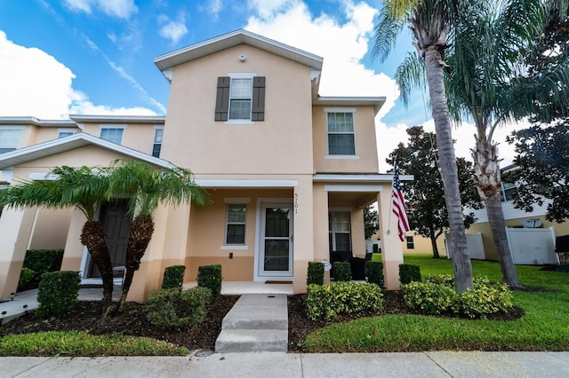 5101 Staniard Dr, Kissimmee, FL 34746 - multi unit property with stucco siding, fence, a front lawn, and covered porch