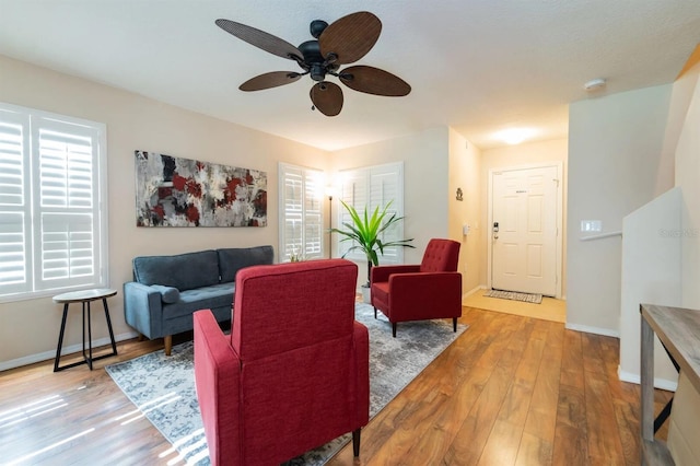 5101 Staniard Dr, Kissimmee, FL 34746 - living area with plenty of natural light, ceiling fan, baseboards, and wood finished floors
