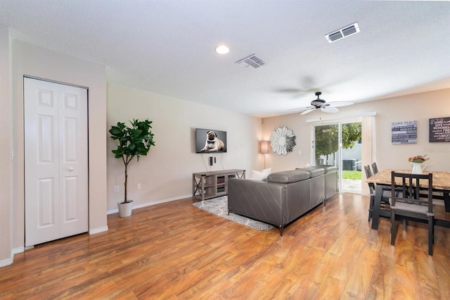 5101 Staniard Dr, Kissimmee, FL 34746 - living room featuring visible vents, baseboards, a ceiling fan, and light wood-style floors
