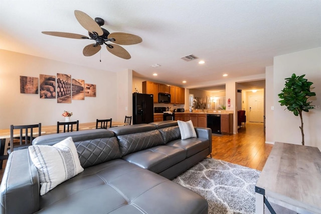 5101 Staniard Dr, Kissimmee, FL 34746 - living area with ceiling fan, wood-type flooring, visible vents, and recessed lighting